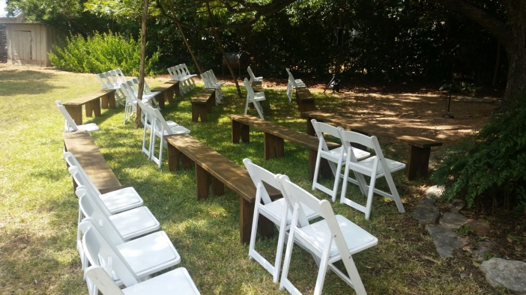 Benches with White Folding Chairs at Ceremony
