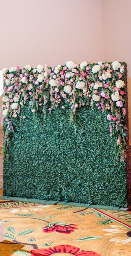 Hedge Wall Used as Photo Backdrop with Floral Attached by Florist